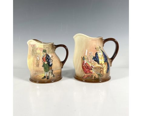 This charming pair of earth-tone pitchers depicts scenes from Charles Dickens works in high relief, with one showcasing Mr. P