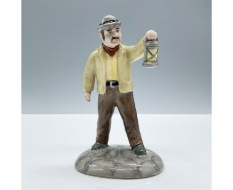 Glazed finish. Modeled in a yellow vest and jacket with brown trousers, holding a lamp. Beswick Beatrix Potter backstamp. Thi