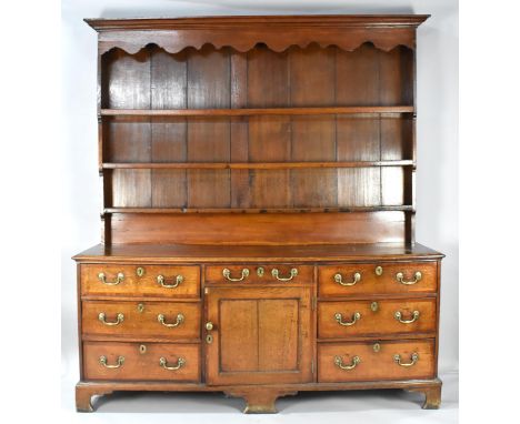 A Good George III Cheshire Dresser in Oak with Mahogany Cross Banding to Top and Drawers. On Bracket Feet. Centre Drawer Over