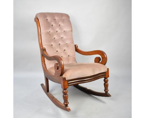 A Reupholstered Mahogany Framed Victorian Rocking Chair with Button Back and Scrolled Arms 