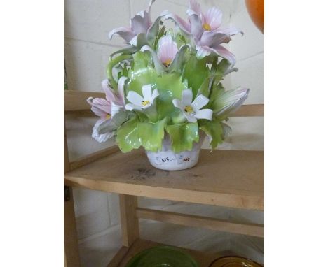 A pottery model of a vase of lilies and other flowers