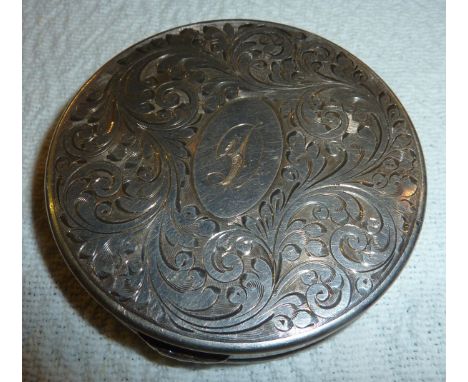 Silver circular compact with engraved floral scrolls