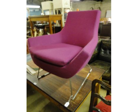 A Swedese Happy armchair on chrome sled base with pink upholstery designed by Roger Persson