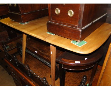 An Ercol light elm dropleaf dining table