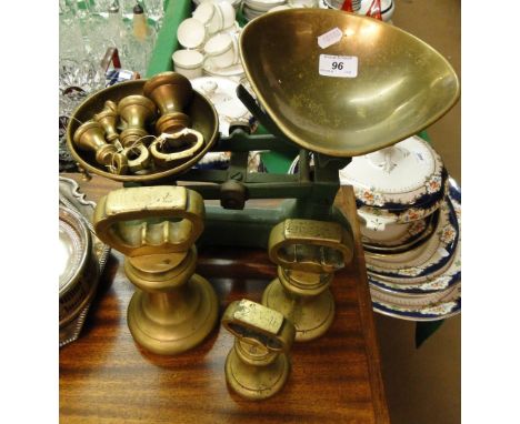 A pair of green enamelled scales with brass pans and 10 brass bell weights.