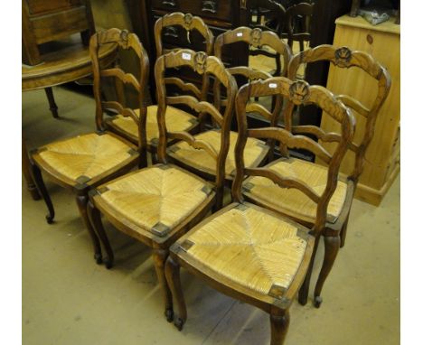 A set of 6 French oak ladder back rush seated dining chairs.