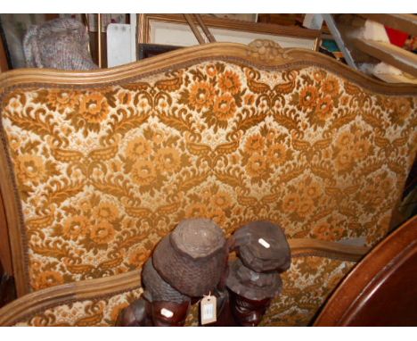 An early 20th C French oak framed bed with floral, cushioned head and footboard