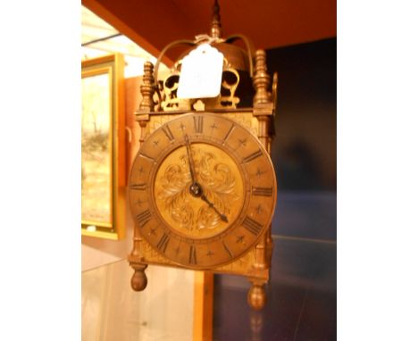 A 19th C brass lantern clock of architectural form, the dial with Roman numeral and the movement stamped V.A.P Brevete 