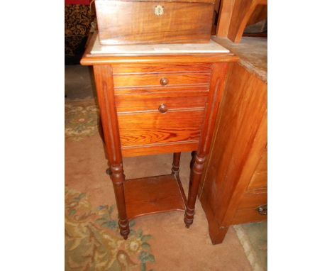 An early 20th C French pine pot cupboard with marble top over a single drawer and enamel lined cupboard, raised on turned sup