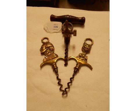 A vintage wooden handled Champagne cork screw with tap and two brass corkscrews