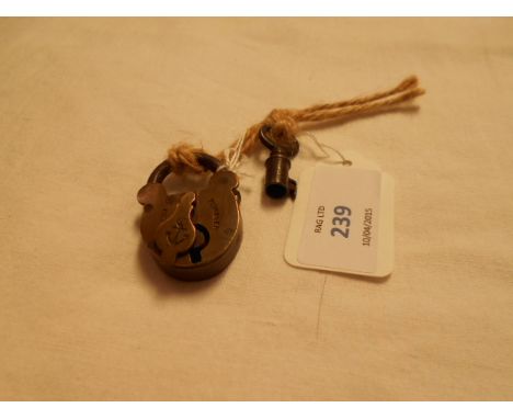 A vintage brass naval tumbler padlock with key