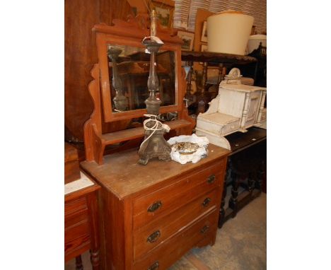 An Edwardian stain wood dressing table fitted with a shaped mirror and shelf below over three graduated drawers with brass sw