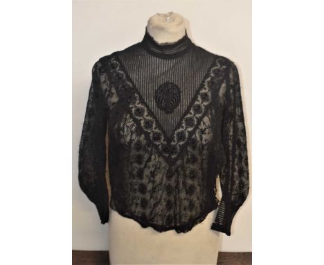 A late 19th / early 20th century black lace blouse, with high neck V-panelled front and all over lace body and sleeves       