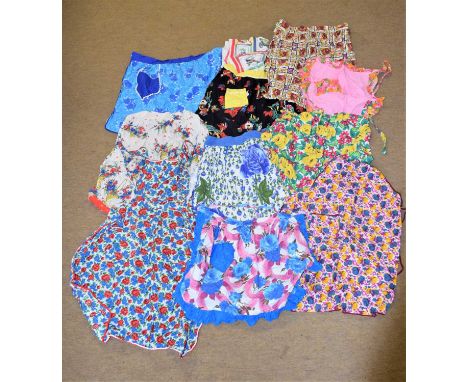 A quantity of vintage cotton printed hostess / cocktail aprons