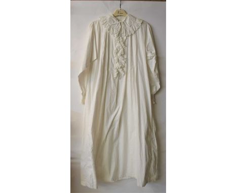 A white cotton nightgown, with peter pan collar and broderie anglaise trim, button and loop opening to neck and double feathe