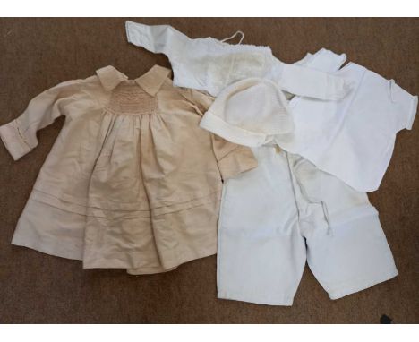 A quantity of vintage childrens clothes to include a cream silk dress with smocking and pale pink embroidery to front, colour