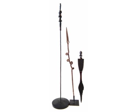 Two African Luba/Hemba wands/staffs, also a twisted iron arrow, the largest measures 145cm high.  Please note VAT is to be pa