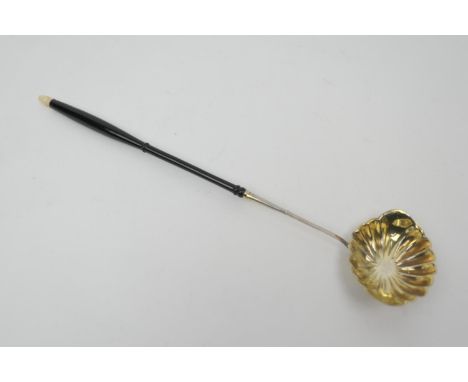 Silver gilt brandy ladle, indistinctly marked, 19th Century, with turned ebony handle with ivory acorn finial, 39.5cm 