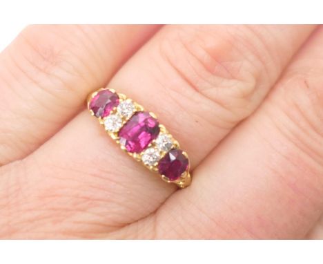 Edwardian ruby and diamond cluster ring, Birmingham 1906, set with three cushion cut rubies dispersed with four old brilliant