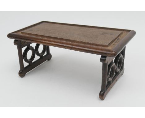 Unusual Oriental style hardwood folding jardiniere stand, circa 1900, rectangular form with folding carved bracket legs, 29cm