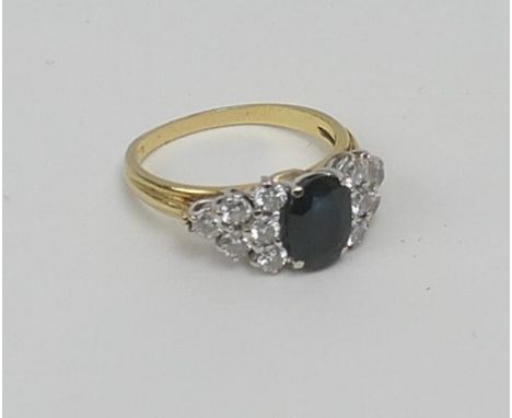 Sapphire and diamond cluster ring, centred with an oval cut sapphire of approx. 1.5cts, flanked on either side with six round