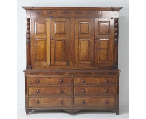 George III oak and mahogany housekeeper's cupboard, circa 1800-30, moulded cornice over four double fielded panel doors, cros