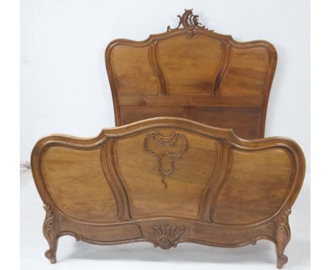 French walnut bed in Louis XV style, having a triple panelled headboard surmounted with a C-form crest, similarly panelled fo