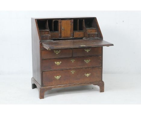 George I oak bureau, circa 1720, fitted interior with secret drawers, small drawers and central pigeonhole, with well beneath