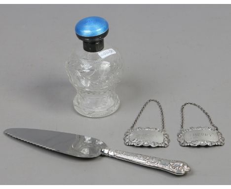 A silver and guilloche enamel cut glass scent bottle, pair of silver decanter labels and a silver handled kings pattern cake 