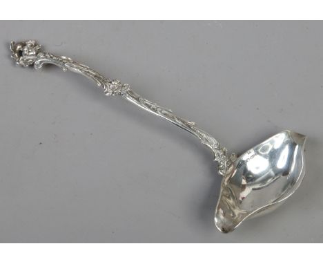 An early C20th continental silver punch ladle with figured terminal and scrolling handle British import marks for Boaz Moses 