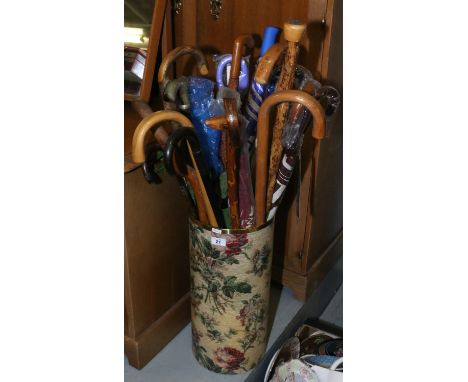 A floral stick stand and contents, variety of sticks and umbrellas etc