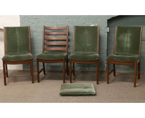 Four teak ladder back upholstered dining chairs with removable backs.