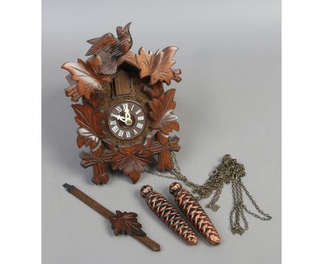 A carved eight day cuckoo clock.