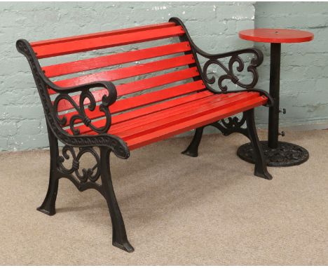 An iron garden bench and similar table.