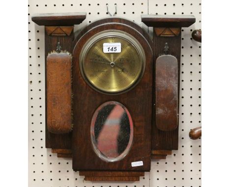 An Art Deco oak mirrored barometer and brush set.
