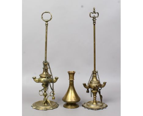 Two Middle Eastern bronze oil lamps possibly Persian, along with a bronze hookah base.
