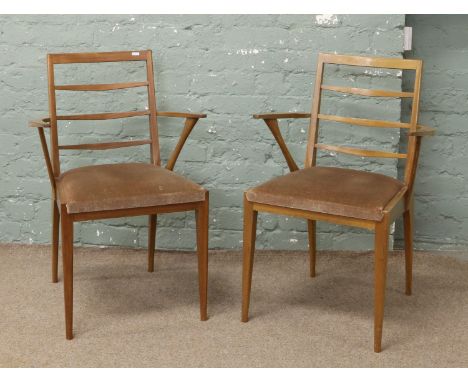 A pair of retro teak ladder back carver dining chairs.