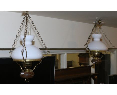 A pair of 230 volt ceiling lights in the form of old parafin lamp with milchglas shade and clear glass chimneys.