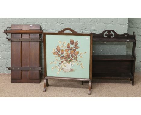 A 1940s oak hanging three tier wall shelf an embroidered firescreen and an oak trouser press.