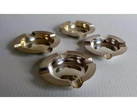 Four Birmingham silver ash trays with engine-turned design by William Adams Ltd, 1932, each 7.5 cm diameter, 126g 