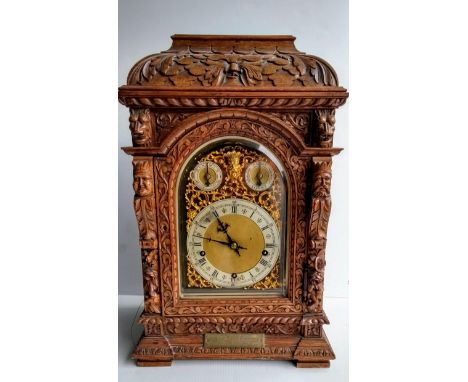 A 19th century German oak-cased three-train bracket clock by Winterhalder &amp; Hofmeier, circa 1880, the elaborately carved 