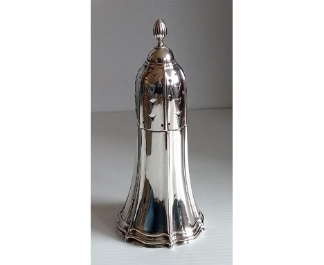 A George V silver sugar caster of conical form with fluted decoration, pierced fluted cover and flame finial by Walker & Hall