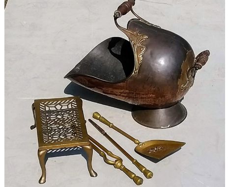 A Victorian copper and brass coal helmet, brass trivet and fire irons (3) 