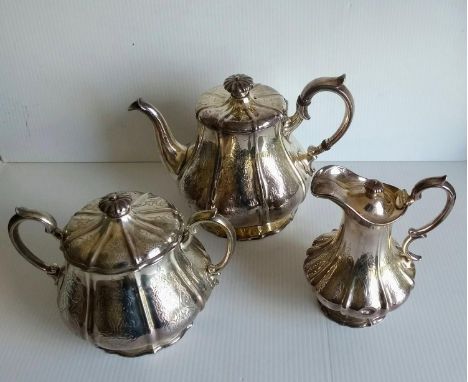 A Victorian silver three-piece tea set comprising teapot, two-handled sugar basin with lid and coffee jug with chased rococo 