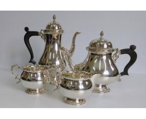 A Georgian-style silver four-piece tea and coffee service, matching jug and sugar bowl with gadroon edge decoration, ebony ha