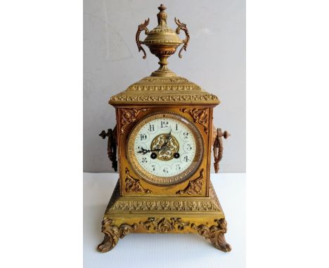 A 19th century brass-cast French mantel clock with architectural features, mechanism by Japy Freres, dial with Arabic numeral