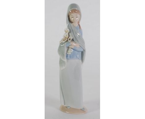 LLADRO PORCELAIN FIGURE, of a girl carrying white lilies, 9 1/4" (23.5cm) high, TOGETHER WITH A NAO PORCELAIN FIGURE  of girl