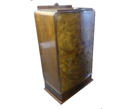 ART DECO BUR-WALNUT COCKTAIL CABINET ABOVE THREE LONG DRAWERS, THE HINGED DOORS OPENING TO REVEAL A SINGLE SHELF WITH PULL OU