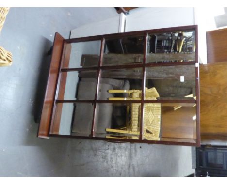 A MAHOGANY 'WATERFALL' TYPE OPEN BOOKCASE AND MAHOGANY FRAMED PANE PATTERN WALL MIRROR WITH DISPLAY SHELF (2) 