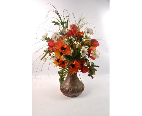 Vintage copper jug with plastic floral arrangement